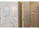 Bathroom featuring a tiled shower with glass door and a large vanity with double sinks at 1552 Fairview Cir, Reunion, FL 34747