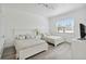 Bright bedroom featuring two beds, wood-look floors, and a window, creating a serene and inviting space at 1552 Fairview Cir, Reunion, FL 34747