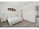 Bright bedroom featuring a queen bed, wood-look floors, and closet at 1552 Fairview Cir, Reunion, FL 34747
