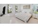 Bright bedroom with white bedding, tile floors, and ample natural light from windows at 1552 Fairview Cir, Reunion, FL 34747