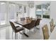 Well-lit dining area with tile floors and backyard view through windows and glass doors at 1552 Fairview Cir, Reunion, FL 34747