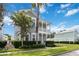 Attractive two-story home with a welcoming double porch, complemented by lush landscaping at 1552 Fairview Cir, Reunion, FL 34747