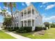 Two-story home with inviting double porches, manicured hedges, and a well-kept green lawn at 1552 Fairview Cir, Reunion, FL 34747