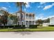 Beautiful two-story home with double porch and manicured lawn, set against a backdrop of blue skies at 1552 Fairview Cir, Reunion, FL 34747