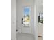 Bright, inviting foyer featuring a door with window and blinds, with tiled flooring and white walls at 1552 Fairview Cir, Reunion, FL 34747