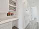 Hallway with a built-in desk area, upper cabinets, and wood-look tile flooring at 1552 Fairview Cir, Reunion, FL 34747