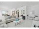 Bright and airy living room with open layout, stylish decor, and gleaming white tile floors at 1552 Fairview Cir, Reunion, FL 34747
