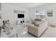 Modern living room with white tile flooring, contemporary furniture, and plenty of natural light at 1552 Fairview Cir, Reunion, FL 34747