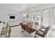 Open living space with tile floors, modern dining set, and a glimpse of the pool at 1552 Fairview Cir, Reunion, FL 34747