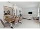 Open floor plan with kitchen, dining, and living area, tile floors, and contemporary lighting at 1552 Fairview Cir, Reunion, FL 34747