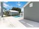Backyard pool area with white fence and view of detached garage on sunny day at 1552 Fairview Cir, Reunion, FL 34747