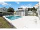 Backyard swimming pool and spa surrounded by a white concrete deck, perfect for outdoor relaxation and entertainment at 1552 Fairview Cir, Reunion, FL 34747