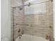 Modern bathroom with a tiled shower, glass door and brushed nickel fixtures at 1552 Fairview Cir, Reunion, FL 34747