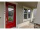 Inviting entryway featuring a vibrant red door and brick paver walkway with a digital lock at 16294 Honey Harvest St, Winter Garden, FL 34787