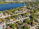 This aerial view displays a neighborhood close to a lake and surrounding trees at 1716 2Nd Ne St, Winter Haven, FL 33881