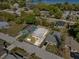 An aerial view shows the home's location on a corner lot near other homes and trees at 1716 2Nd Ne St, Winter Haven, FL 33881