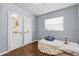 Bedroom with hardwood floors, a single bed near a window, and closet doors adorned with colorful stickers at 1716 2Nd Ne St, Winter Haven, FL 33881