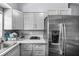 The kitchen features grey shaker cabinets, and a stainless steel refrigerator with water dispenser at 1716 2Nd Ne St, Winter Haven, FL 33881