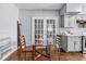 Eat-in kitchen featuring a glass table and white French doors at 1716 2Nd Ne St, Winter Haven, FL 33881