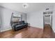 Cozy living room with dark wood floors and comfortable black couch at 1716 2Nd Ne St, Winter Haven, FL 33881