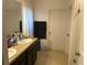 Bathroom featuring dual sinks, granite countertops, and a walk-in shower at 179 Blue Cypress Dr, Davenport, FL 33837