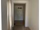 Inviting entryway featuring neutral walls, tile floors, and a view of the front door and chandelier at 179 Blue Cypress Dr, Davenport, FL 33837