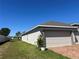 The property featuring a gray fence, green lawn and landscaping at 179 Blue Cypress Dr, Davenport, FL 33837