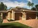 Beautiful home exterior featuring a two-car garage, stucco finish, and meticulously maintained landscaping at 179 Blue Cypress Dr, Davenport, FL 33837