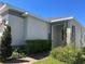 Charming home entrance featuring a stucco exterior, manicured lawn, and brick pavers at 179 Blue Cypress Dr, Davenport, FL 33837