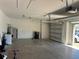 View of a spacious garage with painted walls and access to the outside at 179 Blue Cypress Dr, Davenport, FL 33837