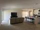 Open concept living room and kitchen area with carpeted floors and sliding glass door to the outside at 179 Blue Cypress Dr, Davenport, FL 33837