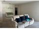 Cozy living room with neutral decor and a comfortable seating arrangement, carpet floors and a view of the Main bedroom at 179 Blue Cypress Dr, Davenport, FL 33837