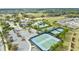 Aerial view of the tennis courts, and clubhouse amenities, amidst scenic landscaping at 1830 Estuary Ln, Kissimmee, FL 34747