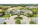 Aerial view of the clubhouse and pool, surrounded by lush landscaping and a manicured golf course at 1830 Estuary Ln, Kissimmee, FL 34747