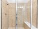 Walk-in shower featuring tile walls and a built-in bench at 1830 Estuary Ln, Kissimmee, FL 34747