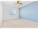 Bedroom with a blue accent wall and a ceiling fan at 1830 Estuary Ln, Kissimmee, FL 34747