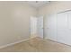 A neutral bedroom offers a ceiling fan, window for natural light and a large closet at 1830 Estuary Ln, Kissimmee, FL 34747