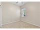 A simple bedroom with a neutral palette, a ceiling fan, and a window for natural light at 1830 Estuary Ln, Kissimmee, FL 34747