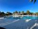 Stunning community pool featuring lounge chairs and lush palms against a clear blue sky at 1830 Estuary Ln, Kissimmee, FL 34747