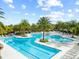 Expansive community pool featuring palm trees, lounge chairs, and multiple pools at 1830 Estuary Ln, Kissimmee, FL 34747