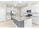 Modern kitchen featuring granite countertops, stainless steel appliances, and a gray tiled kitchen island at 1830 Estuary Ln, Kissimmee, FL 34747