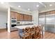 Modern kitchen with stainless steel appliances, a large island, and stylish seating at 1830 Estuary Ln, Kissimmee, FL 34747