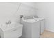 Convenient laundry room with washer, dryer, utility sink, and ample shelving for storage at 1830 Estuary Ln, Kissimmee, FL 34747