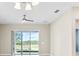 Living room with ceiling fan and sliding glass doors that offer ample natural light and views of the backyard at 1830 Estuary Ln, Kissimmee, FL 34747