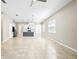 Open-concept living space featuring tile floors and view into the bright kitchen at 1830 Estuary Ln, Kissimmee, FL 34747