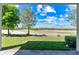 Beautiful view of a golf course seen from a covered patio with stone flooring at 1830 Estuary Ln, Kissimmee, FL 34747