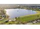Aerial view of a pond, driving range, and lush landscaping at 188 Olympus Way, Kissimmee, FL 34759