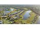Expansive aerial view of residences with a lake and golf course views at 188 Olympus Way, Kissimmee, FL 34759
