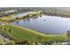 Aerial view of a lake with a driving range and lush green space at 188 Olympus Way, Kissimmee, FL 34759