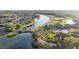Scenic aerial view of a residential community with a lake, golf course, and lush greenery at 188 Olympus Way, Kissimmee, FL 34759